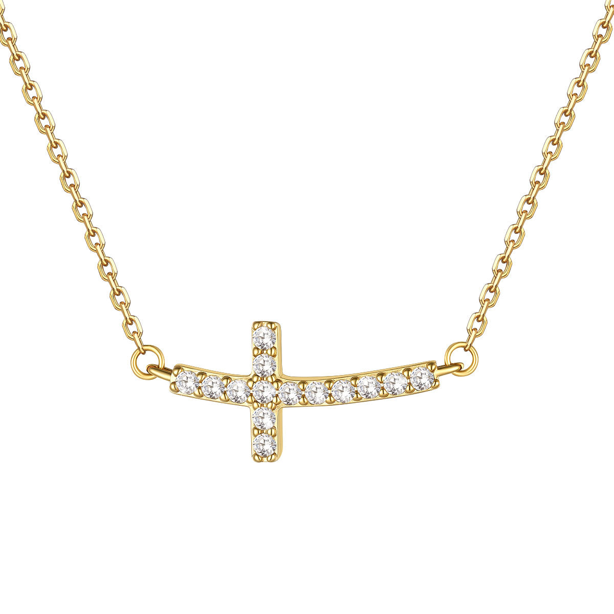 A gold cross necklace featuring a bar and cross pendant set with clear cubic zirconia stones, displayed against a solid white background.