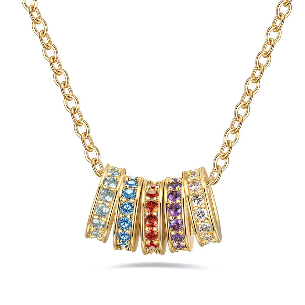 Gold custom stacking birthtone necklace with colorful gemstones on a white background