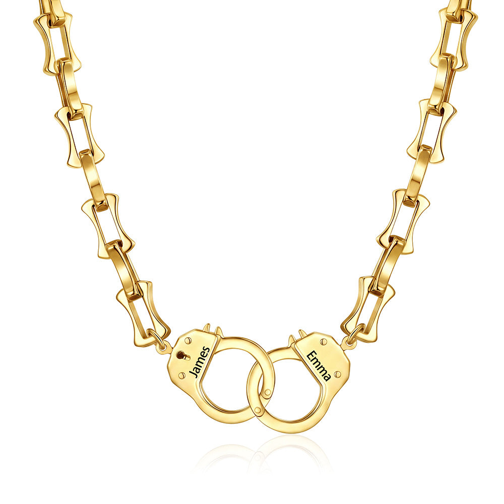 Gold handcuff bamboo link necklace with handcuff pendants engraved with names on a white background