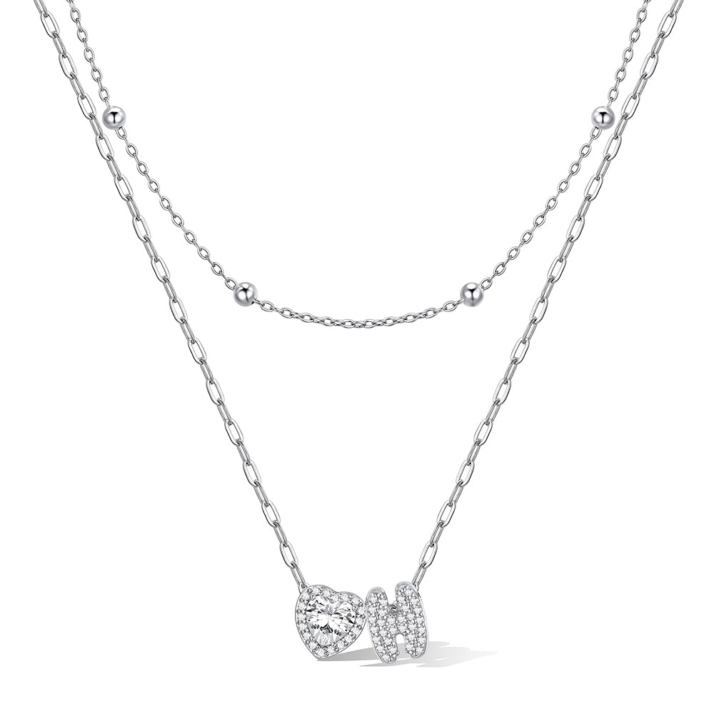 Silver cz bubble initial H necklace with a heart-shaped pendant on a white background