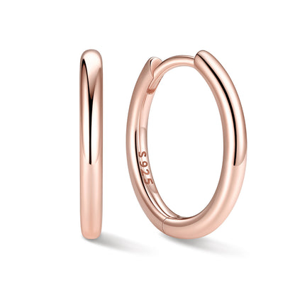 12mm Rose gold huggie earrings on a white background