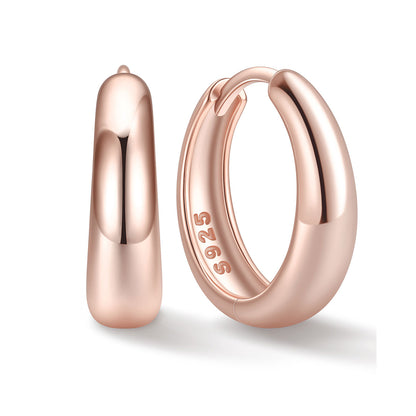 14mm Rose gold huggie earrings on a white background
