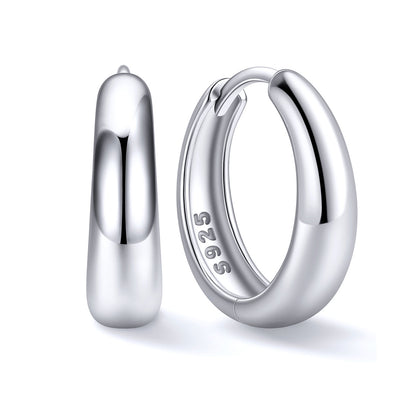 14mm Silver huggie earrings in sterling silver on a white background 