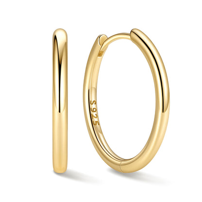 16mm Gold huggie earrings on a white background