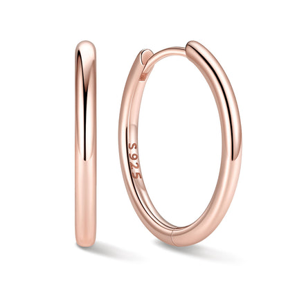 16mm Rose gold huggie earrings on a white background