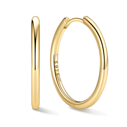 18mm Gold huggie earrings on a white background