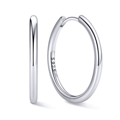 18mm Silver huggie earrings on a white background
