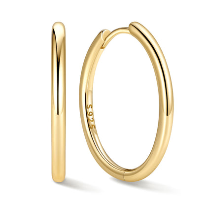 20mm Gold huggie earrings on a white background