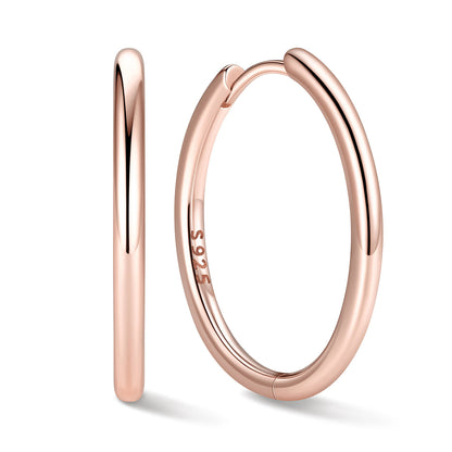 20mm Rose gold huggie earrings on a white background
