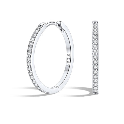 Silver huggie earrings with embedded stones on a white background