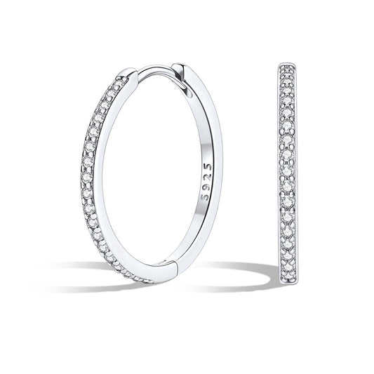 Silver huggie earrings with embedded stones on a white background