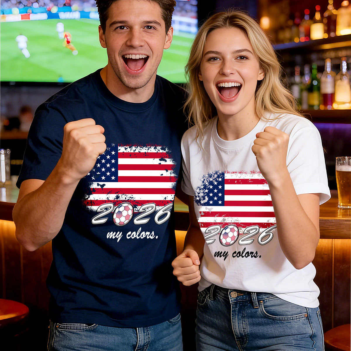 Two people wearing t-shirts with '2026 my colors' design in a bar setting.