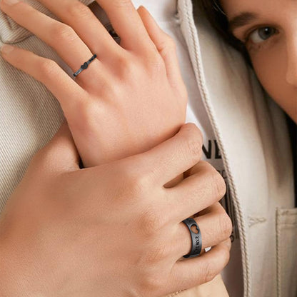 A Couple wearing black matching couple rings with name engraved