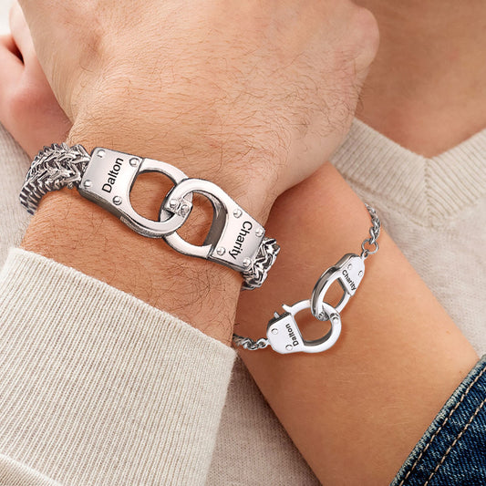 A Couples Wearing Handcuff Chain Bracelet