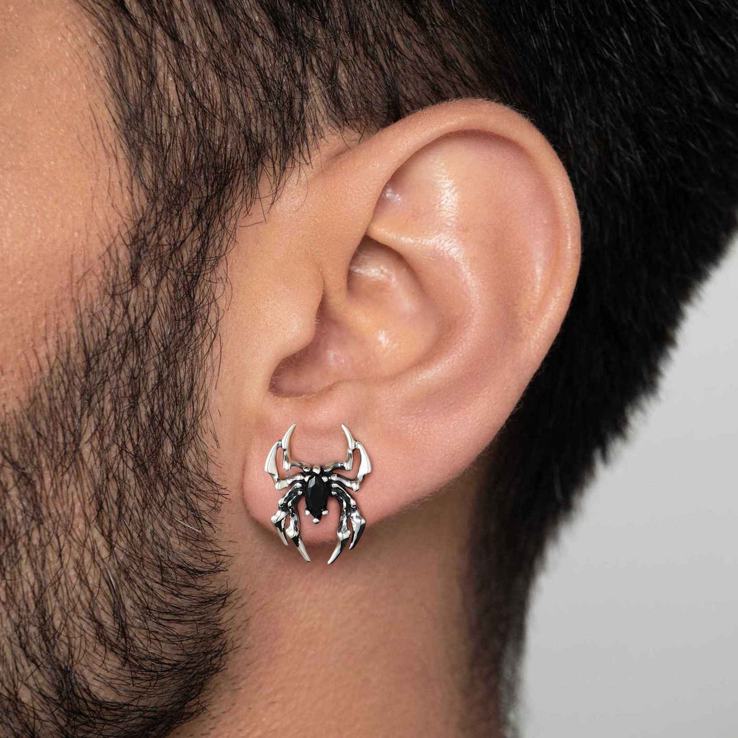 A Man Wearing Black CZ Spider Stud Earrings