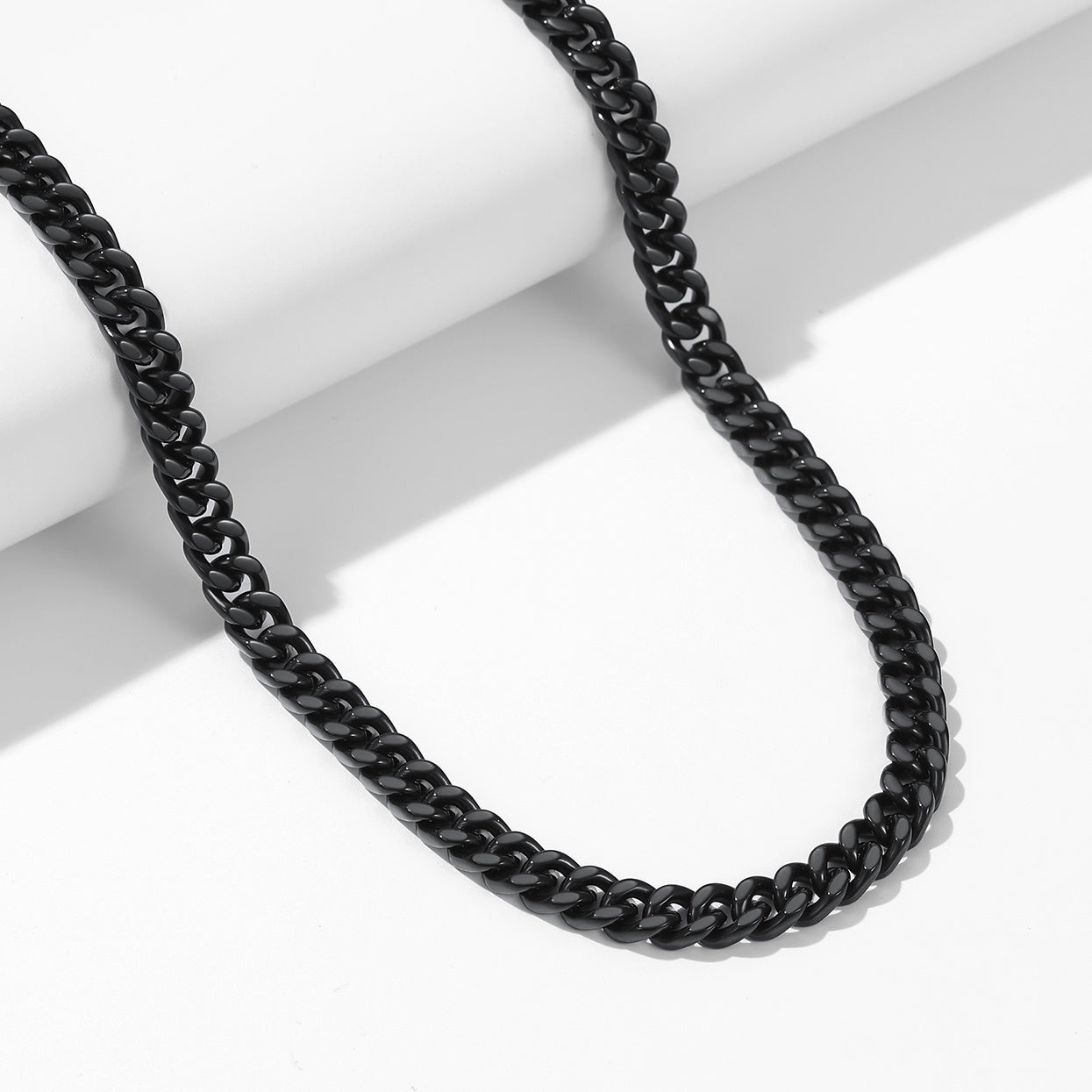 A Man Wearing Custom Engravable Cuban Chain Necklace & Bracelet Set 7MM in Black Plated