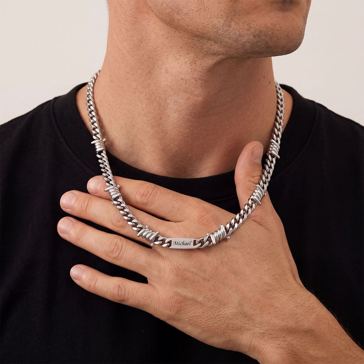 A Man Wearing Custom Multi-Name Barbed Wire Cuban Link Necklace