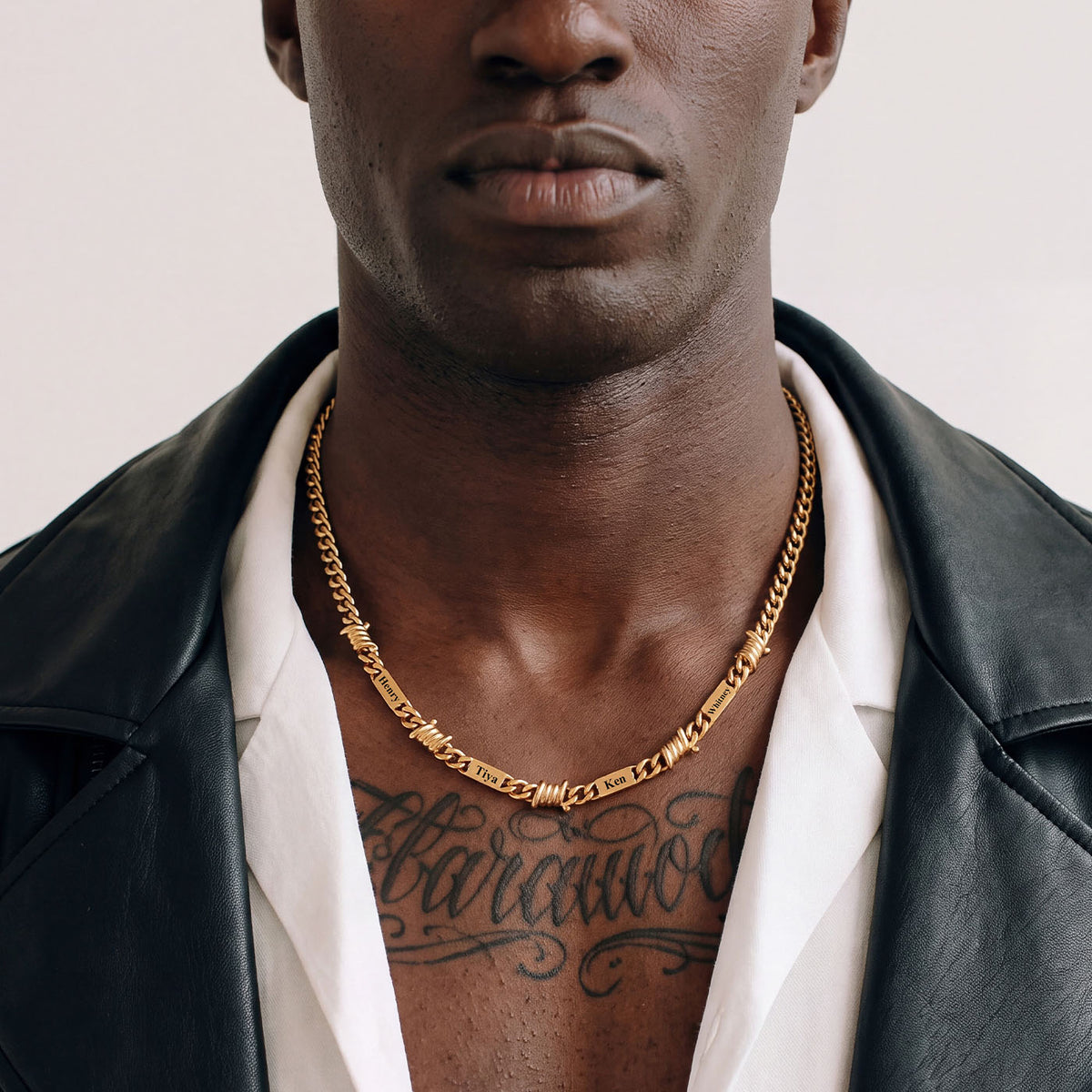 A Man Wearing Gold Plated Custom Multi-Name Barbed Wire Cuban Link Necklace