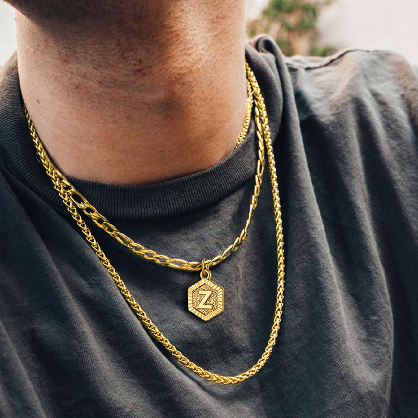 A  Man Wearing Initial Charm Figaro Chain Necklace