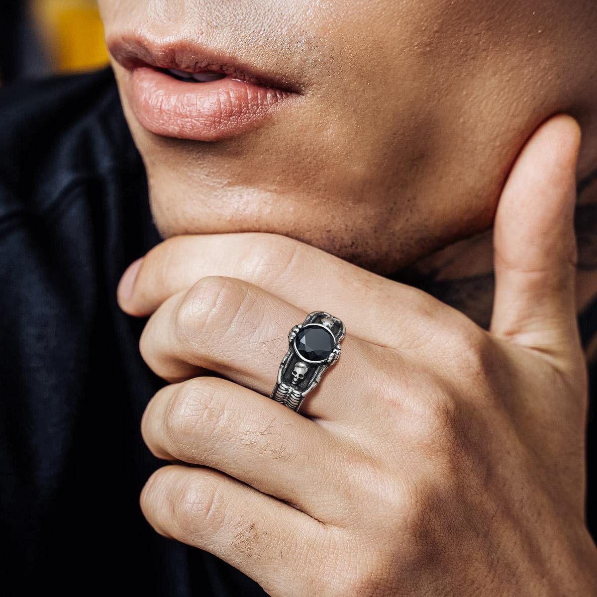 A Man Wearing Skull Gemstone Ring