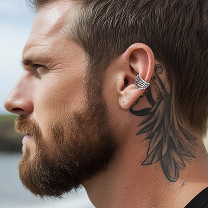 A Man Wearing Skull Hand Ear Cuff Earrings