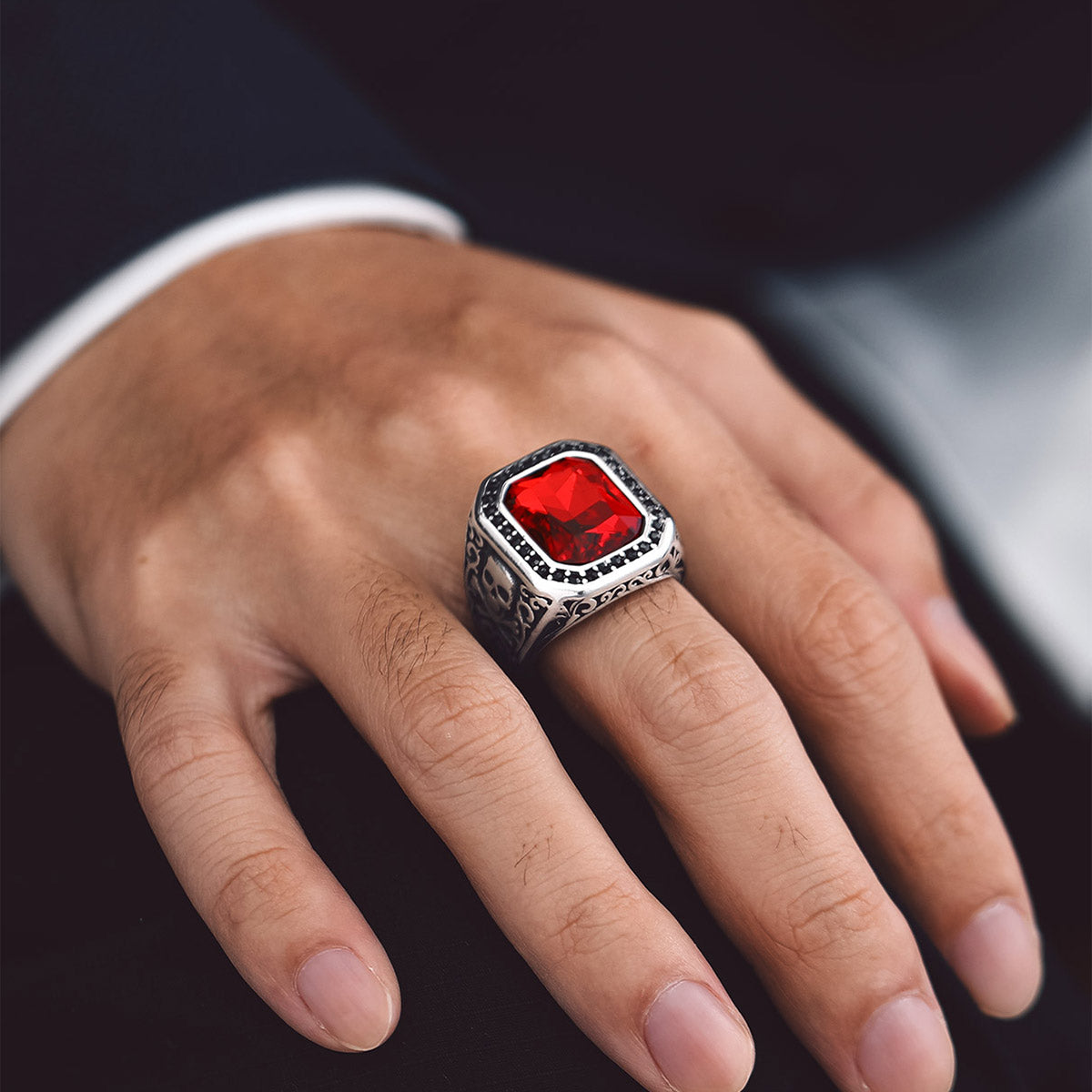 A Man Wearing X Bone Skull Gemstone Ring
