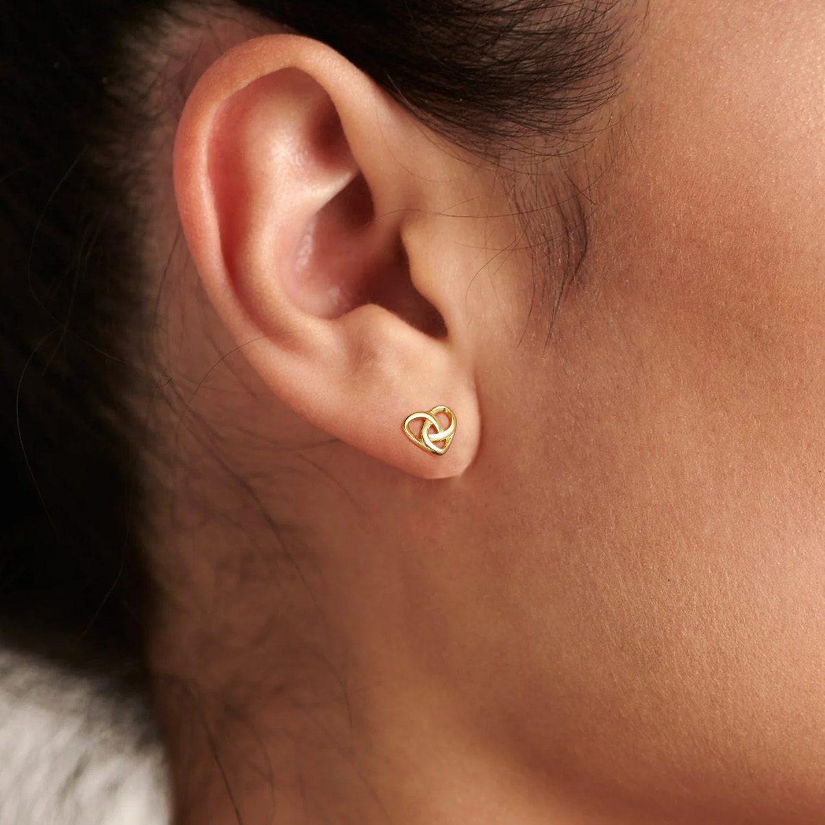 A Woman Wearing 925 Sterling Silver Heart Celtic Knot Stud Earrings for Women