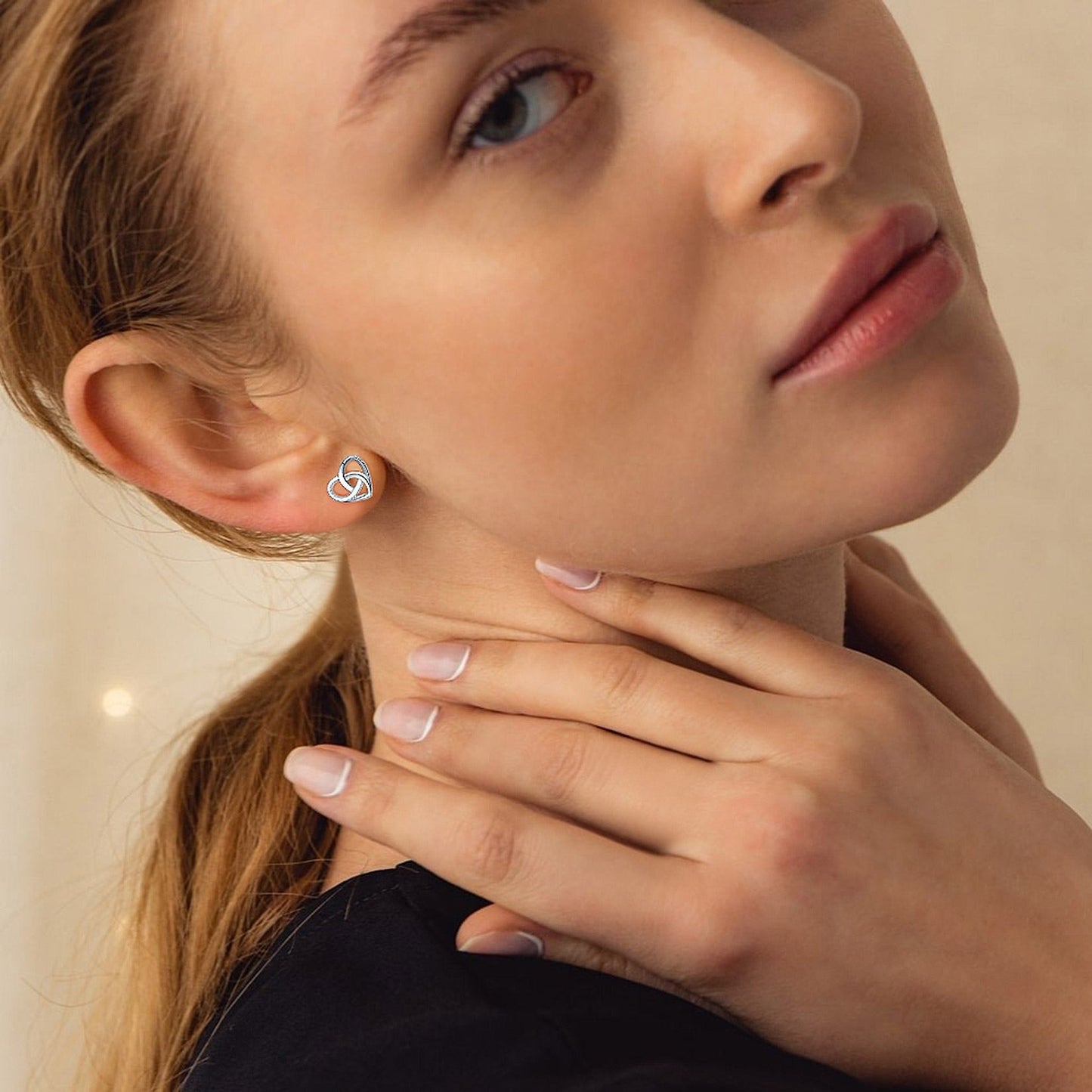 A Woman Wearing 925 Sterling Silver Heart Celtic Knot Stud Earrings silver