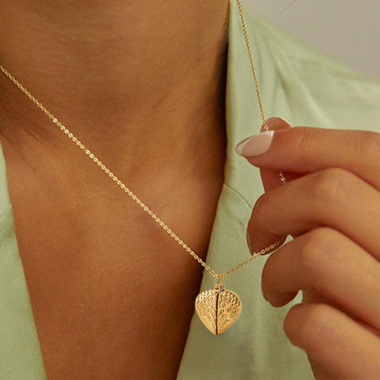 A Woman Wearing Angel Wings Heart Locket Necklace