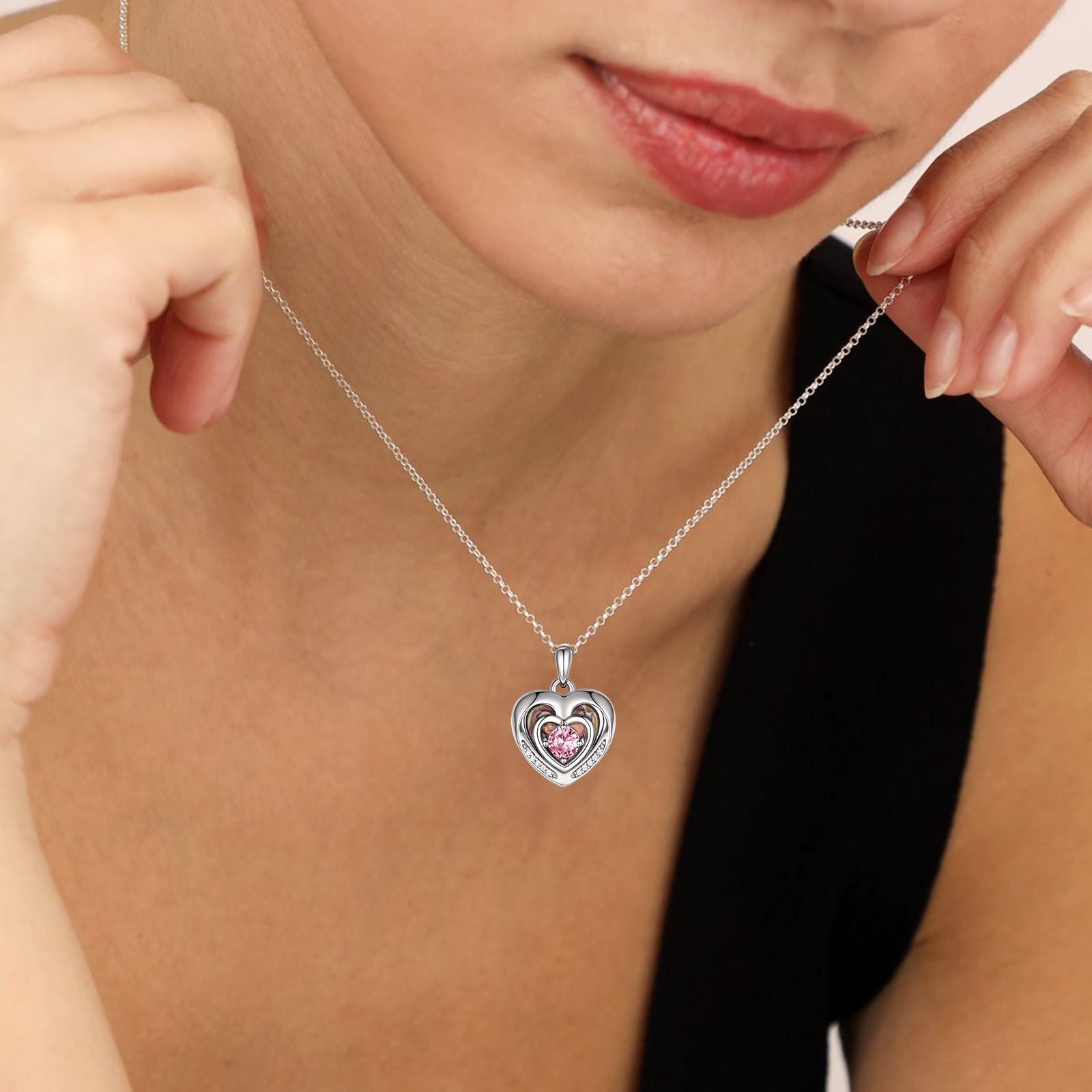 A Woman Wearing Birthstone Heart Photo Locket Necklace in Sterling Silver