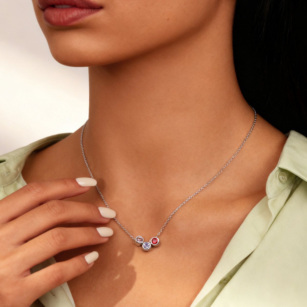 A Woman Wearing Birthstone Necklace with 3 Birthstones
