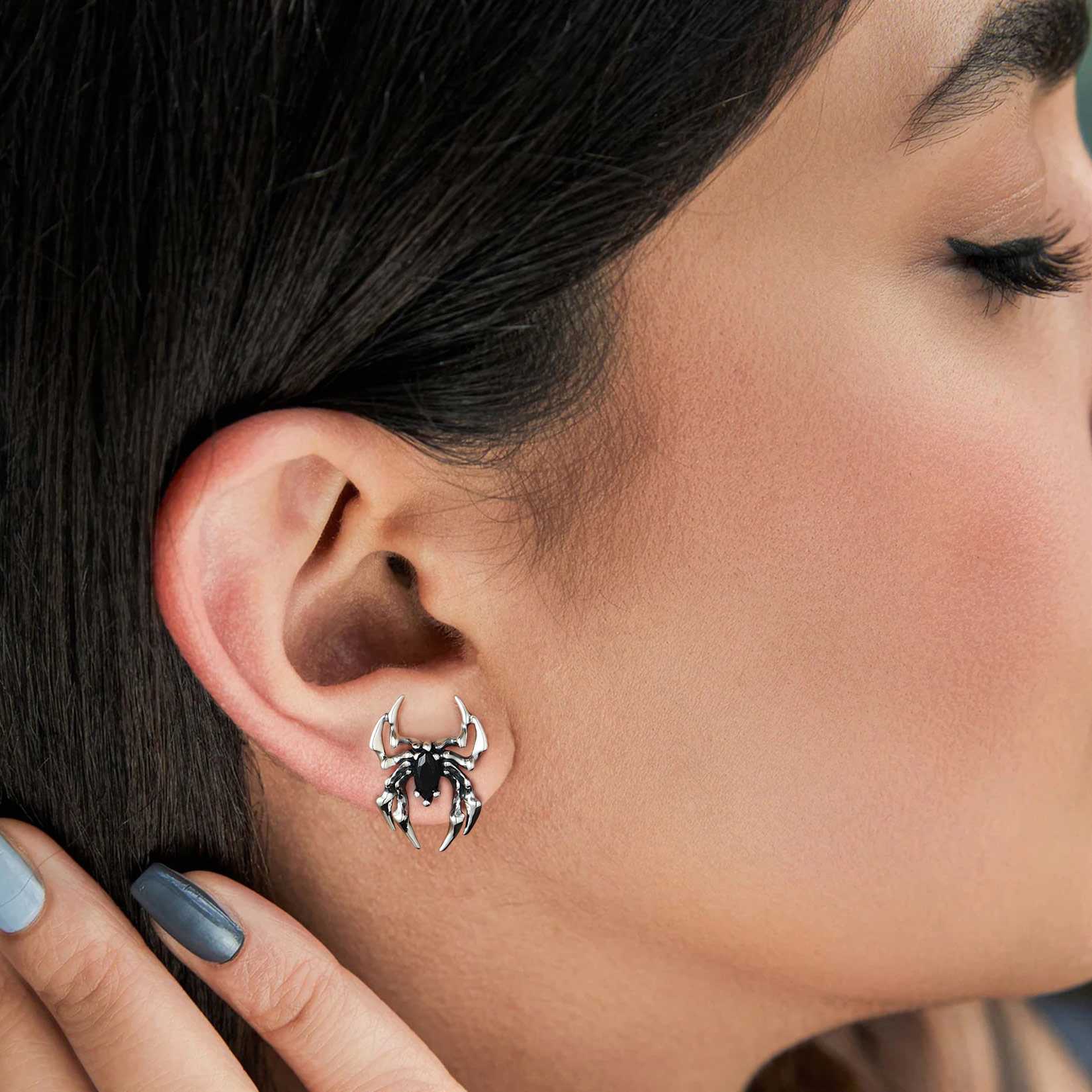 A Woman Wearing Black CZ Spider Stud Earrings
