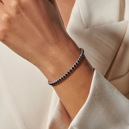 A Woman Wearing Black Cubic Zirconia Tennis Bracelet 