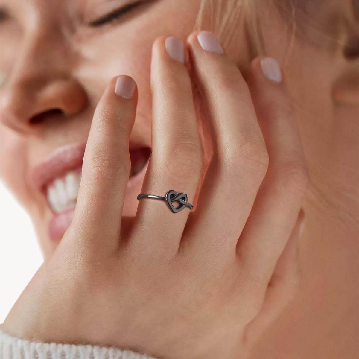 A Woman Wearing Black Plated Silver Heart Love Knot Promise Ring