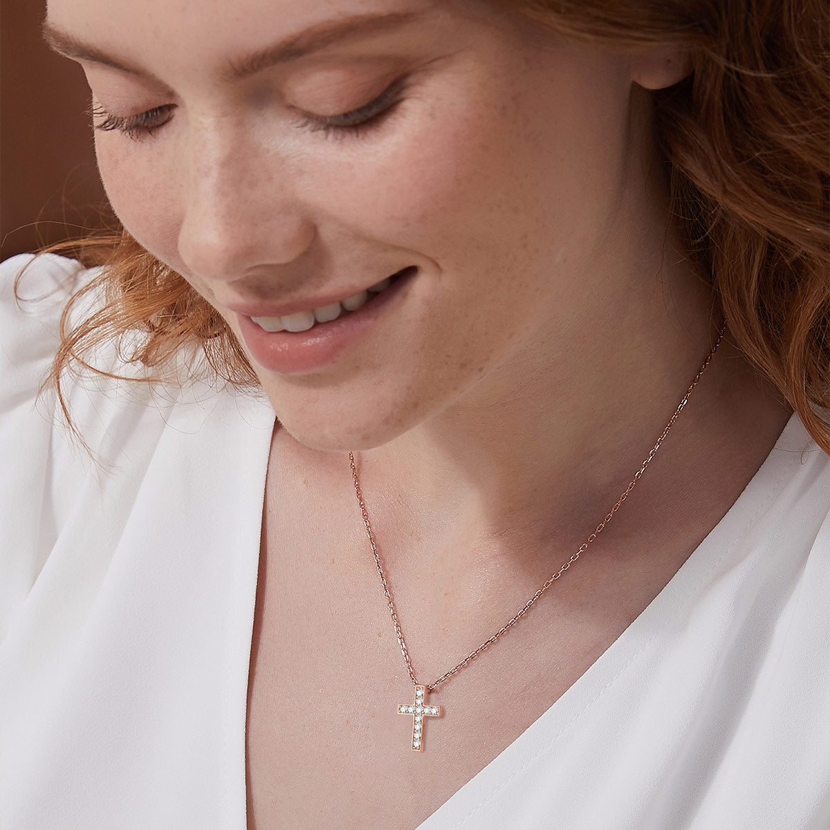 A Woman Wearing CZ Cross Necklace
