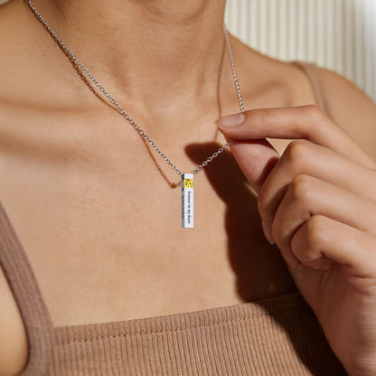 A Woman Wearing Cube Birthstone Urn Necklaces for Ashes