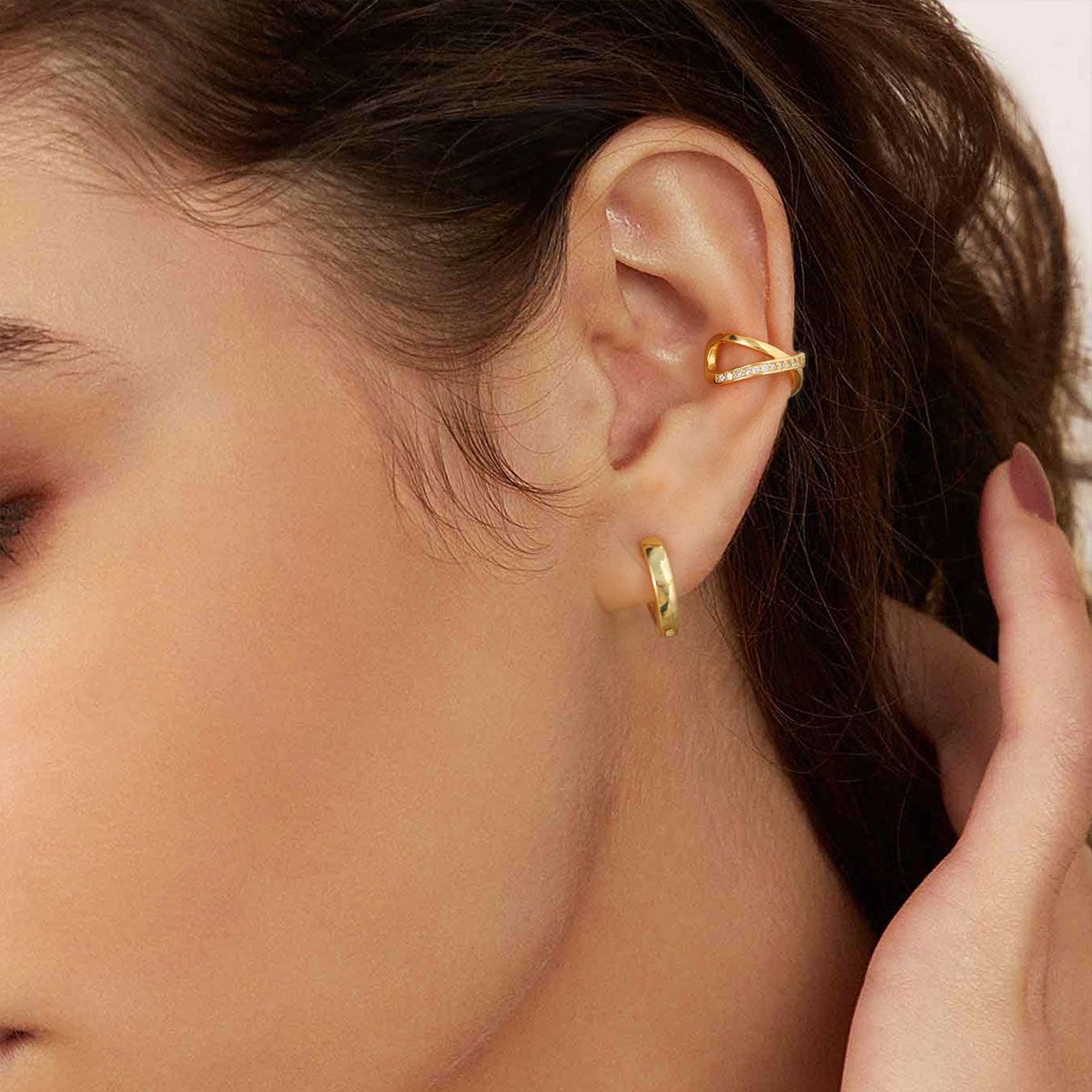 A Woman Wearing Cubic Zirconia Cross Ear Cuff Earrings