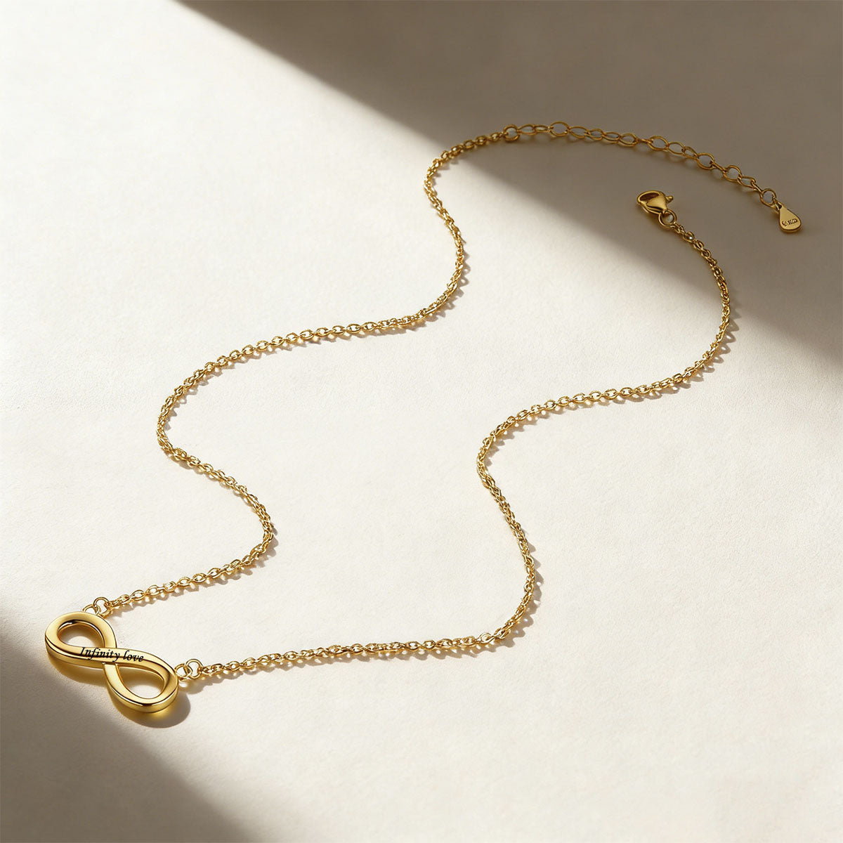 A Woman Wearing Custom Engravable Infinity Necklace in Gold Plated