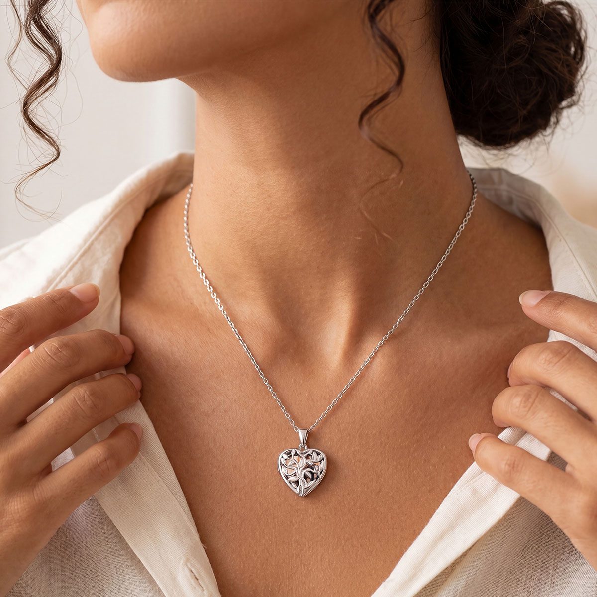 A Woman Wearing Custom Tree of Life Heart Locket Picture Necklace in Sterling Silver