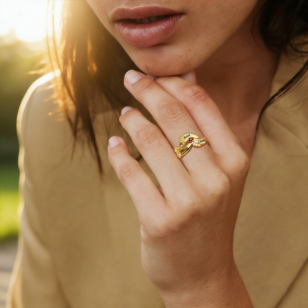 A Woman Wearing Footprint Mother's Birthstone Ring with Names