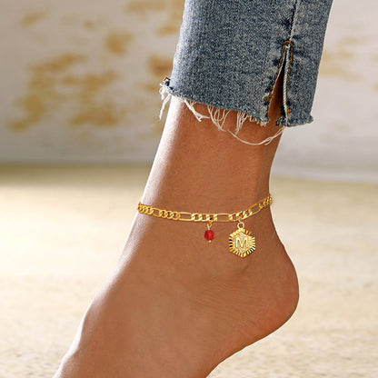 A Woman Wearing Gold Figaro Chain Initial Charm Anklet with Birthstone