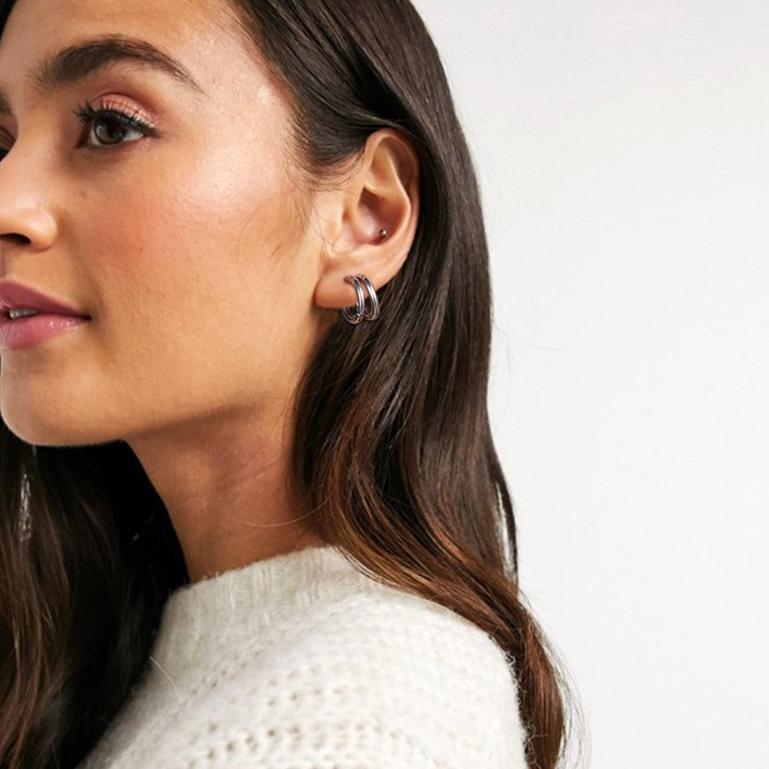 A Woman Wearing Huggie Ear Cuff Clip On Hoop Earrings Set