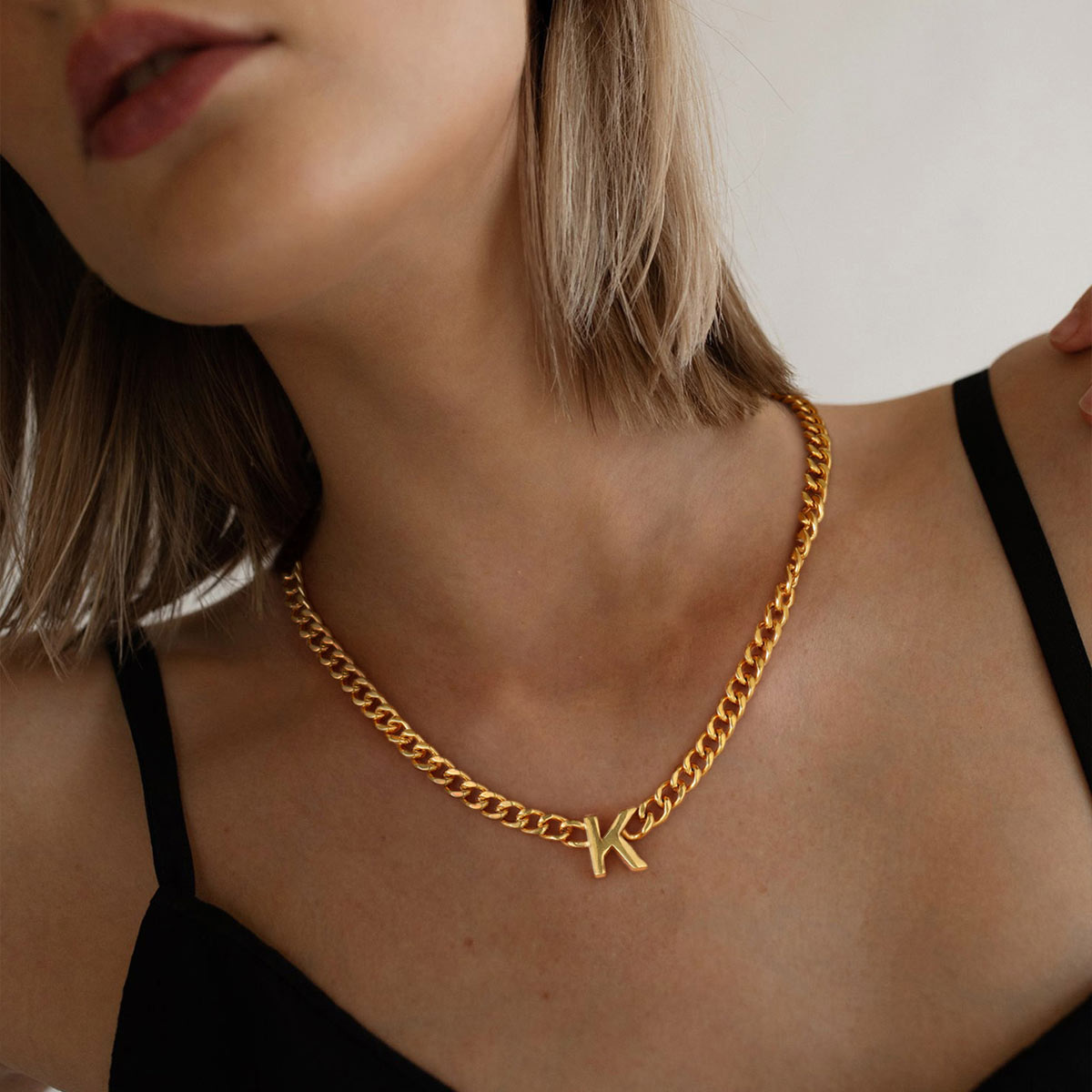 A Woman Wearing Initial Cuban Chain Necklace