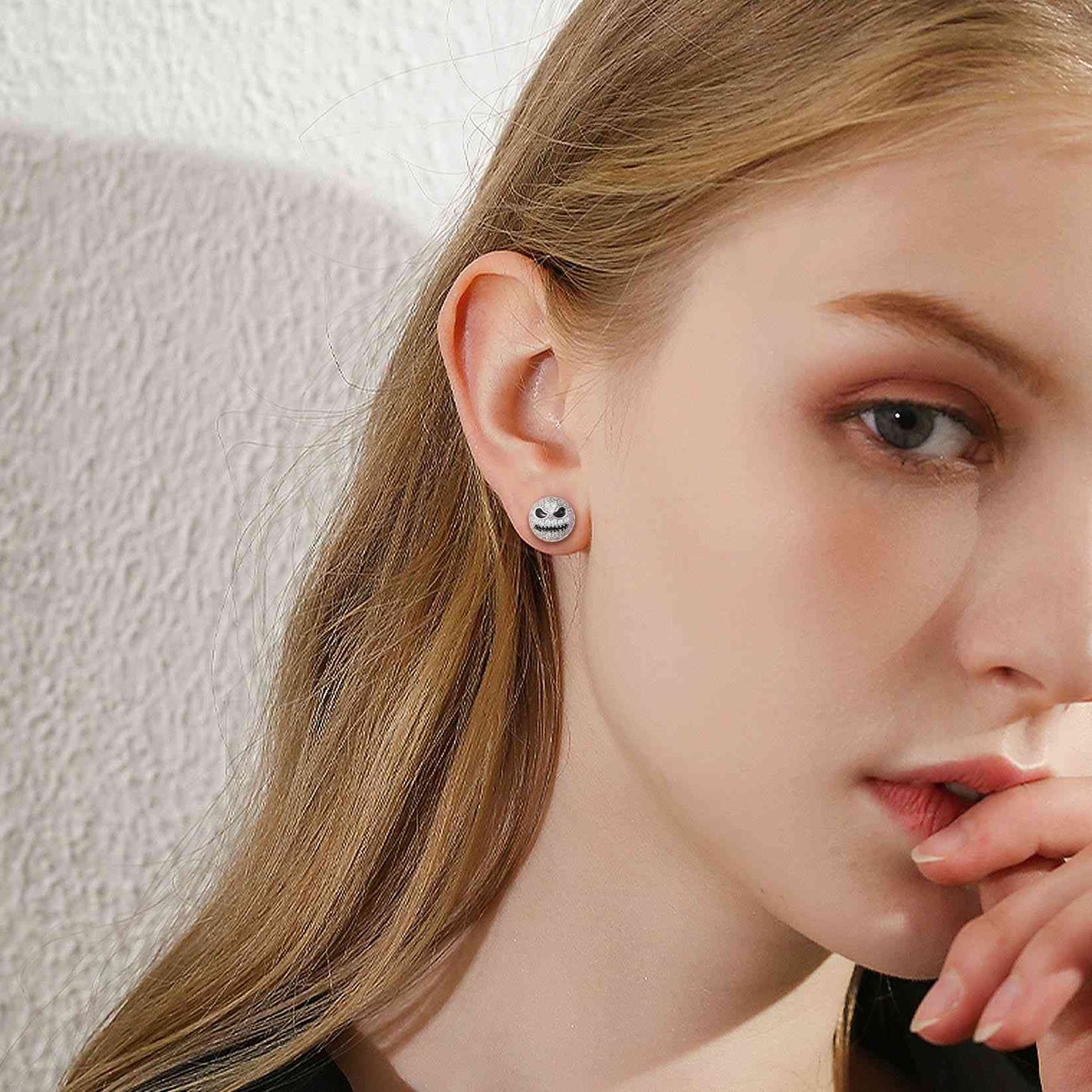 A Woman Wearing Jack Skellington Stud Earrings