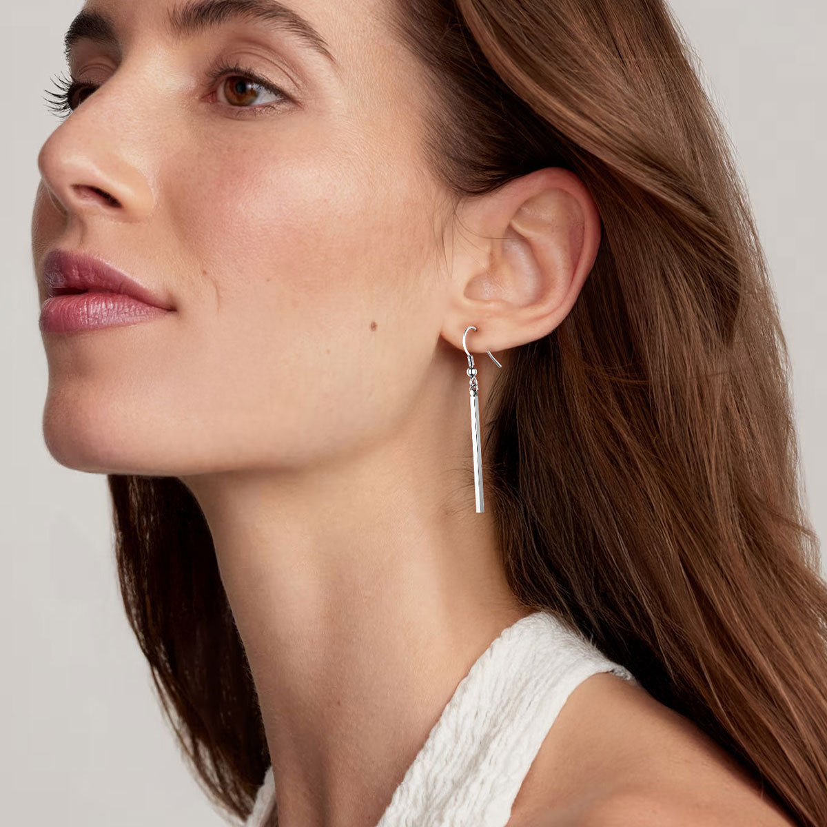 A Woman Wearing Long Vertical Bar Dangle Earrings
