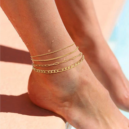 A Woman Wearing Paperclip Cuban Figaro Chain Anklet Set 