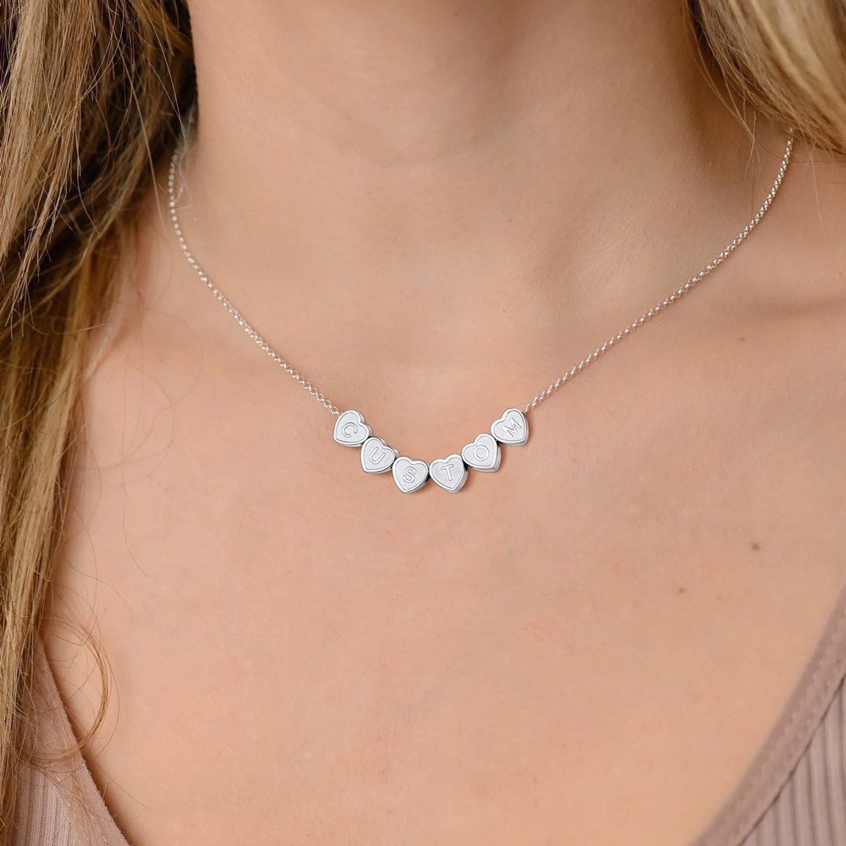 A Woman Wearing Personalized Heart Initial Necklace in 