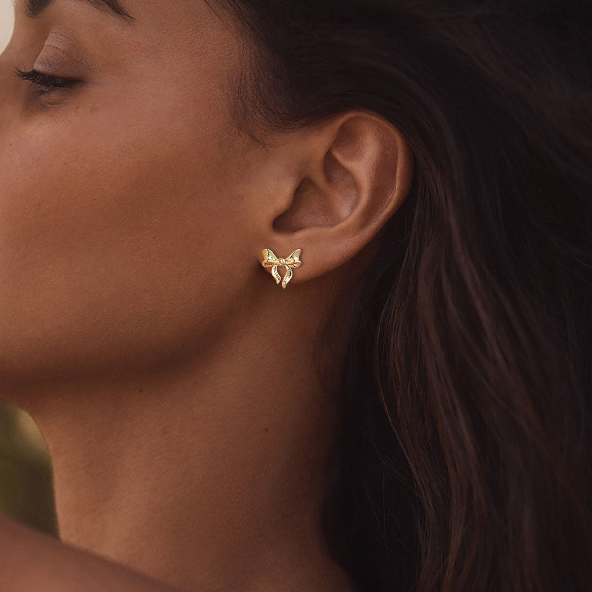 A Woman Wearing Ribbon Bow Earrings