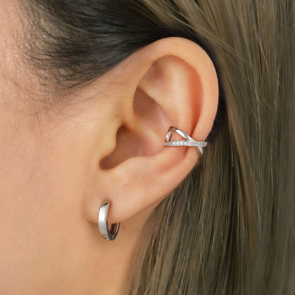 A Woman Wearing Silver Cubic Zirconia Cross Ear Cuff Earrings