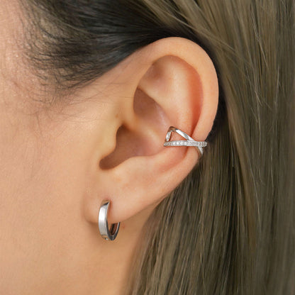 A Woman Wearing Silver Cubic Zirconia Cross Ear Cuff Earrings